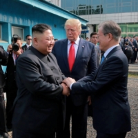 South Korean President Moon Jae-in shakes hands with North Korean leader Kim Jong Un at the demilitarized zone (DMZ) separating the two Koreas, in Panmunjom, South Korea, June 30, 2019. | REUTERS