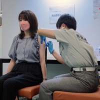 A COVID-19 vaccination center at Aoyama Gakuin University's Aoyama campus in Tokyo | BLOOMBERG