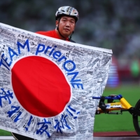 Japan's Tomoki Sato celebrates after winning another gold medal at Paralympic Games in Tokyo on Sunday. | REUTERS