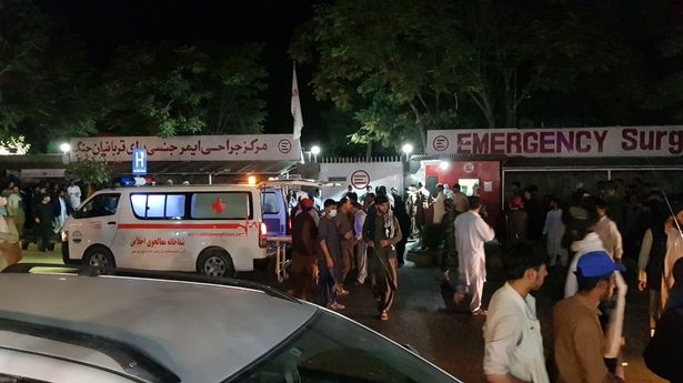 Injured people being carried to a hospital following the deadly blast