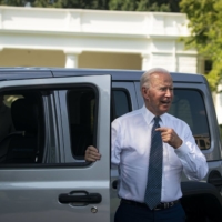 U.S. President Joe Biden speaks to members of the media after driving a Jeep Wrangler Rubicon electric vehicle during an event on the South Lawn of the White House on Thursday. | BLOOMBERG