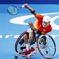 Shingo Kunieda hits a shot during a practice session at Ariake Tennis Park on Sunday. | KYODO