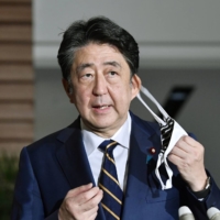 Then-Prime Minister Shinzo Abe responds to questions at the Prime Minister's Office in Tokyo in September 2020. | KYODO