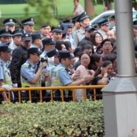 Police remove fans outside the Shanghai International Film Festival in 2014. Beijing regulators have now taken aim at China's entertainment industry for 'severely polluting the social atmosphere.' | REUTERS