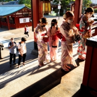 People pray at Sensoji temple in Tokyo's Asakusa district on Aug. 18. | REUTERS