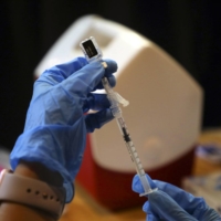 A syringe is filled with a dose of a COVID-19 vaccine at a vaccination center in Rohnert Park, California, in January. Deaths among people who have been fully vaccinated remain rare, but older adults and those with compromised immune systems are at much higher risk. | JIM WILSON / THE NEW YORK TIMES