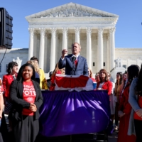 Texas Attorney General Ken Paxton speaks to a crowd of anti-abortion supporters outside the U.S. Supreme Court. | REUTERS