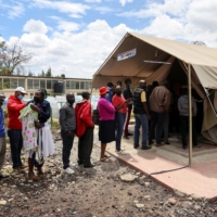 People stand in line to receive a COVID-19 vaccine, at the Narok County Referral Hospital, in Narok, Kenya | REUTERS