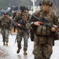 Members of the U.S. Marine Corps and the Ground Self-Defense Force conduct a joint drill at Ojojihara training site in Miyagi Prefecture on Wednesday. | KYODO