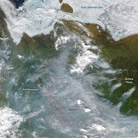 Smoke rises from active fires burning near Verkhoyansk, Russia, on June 23, 2020. The climate has been warming rapidly in the Arctic for years. | NASA / VIA THE NEW YORK TIMES