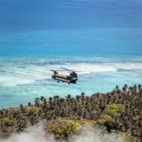 A photo provided by the Australian Defence Force shows an Australian Army helicopter flying over Atata Island, Tonga, on Feb. 3. | DAVID COX / AUSTRALIAN DEFENCE FORCE VIA THE NEW YORK TIMES