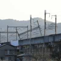 Damaged poles supporting the Tohoku Shinkansen line's overhead wiring in Shiroishi, Miyagi Prefecture, on Thursday | KYODO