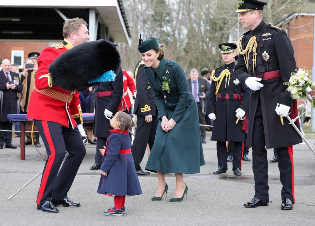 ALDERSHOT, ENGLAND – MARCH 17: Catherine, Duchess of Cambridge and Prince William, Duke of Cambridge smile and laugh as Lieutenant Colonel Rob Money puts a bearskin hat on his 20-month-old daughter Gaia Money’s head as they attend the 1st Battalion Irish Guards’ St. Patrick’s Day Parade at Mons Barracks on March 17, 2022 in Aldershot, England. (Photo by Chris Jackson – WPA Pool/Getty Images)