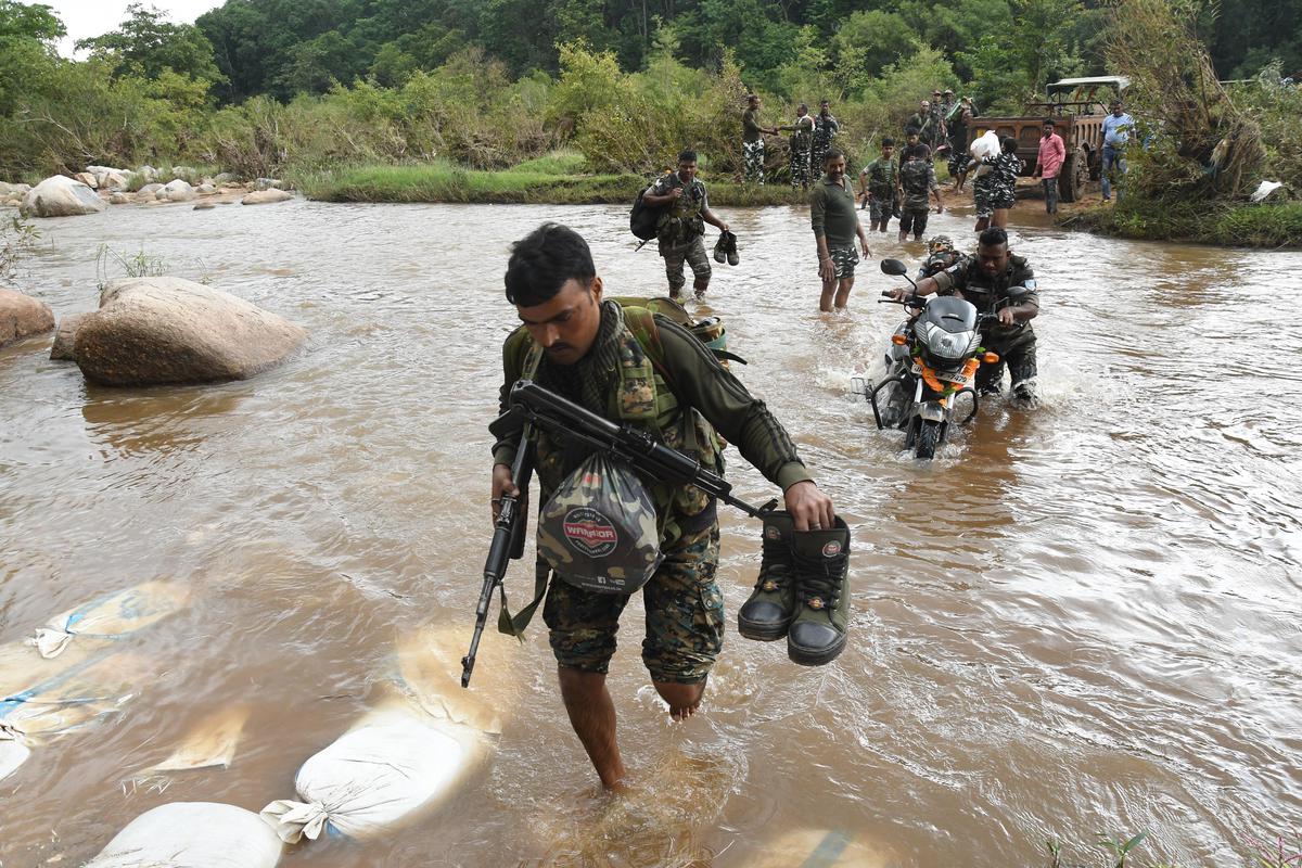 Security forces crossing the Burha river.