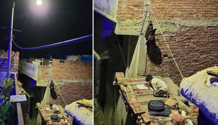 Photo of Kid Studying in Street Light on Roof of Shanty Goes Viral