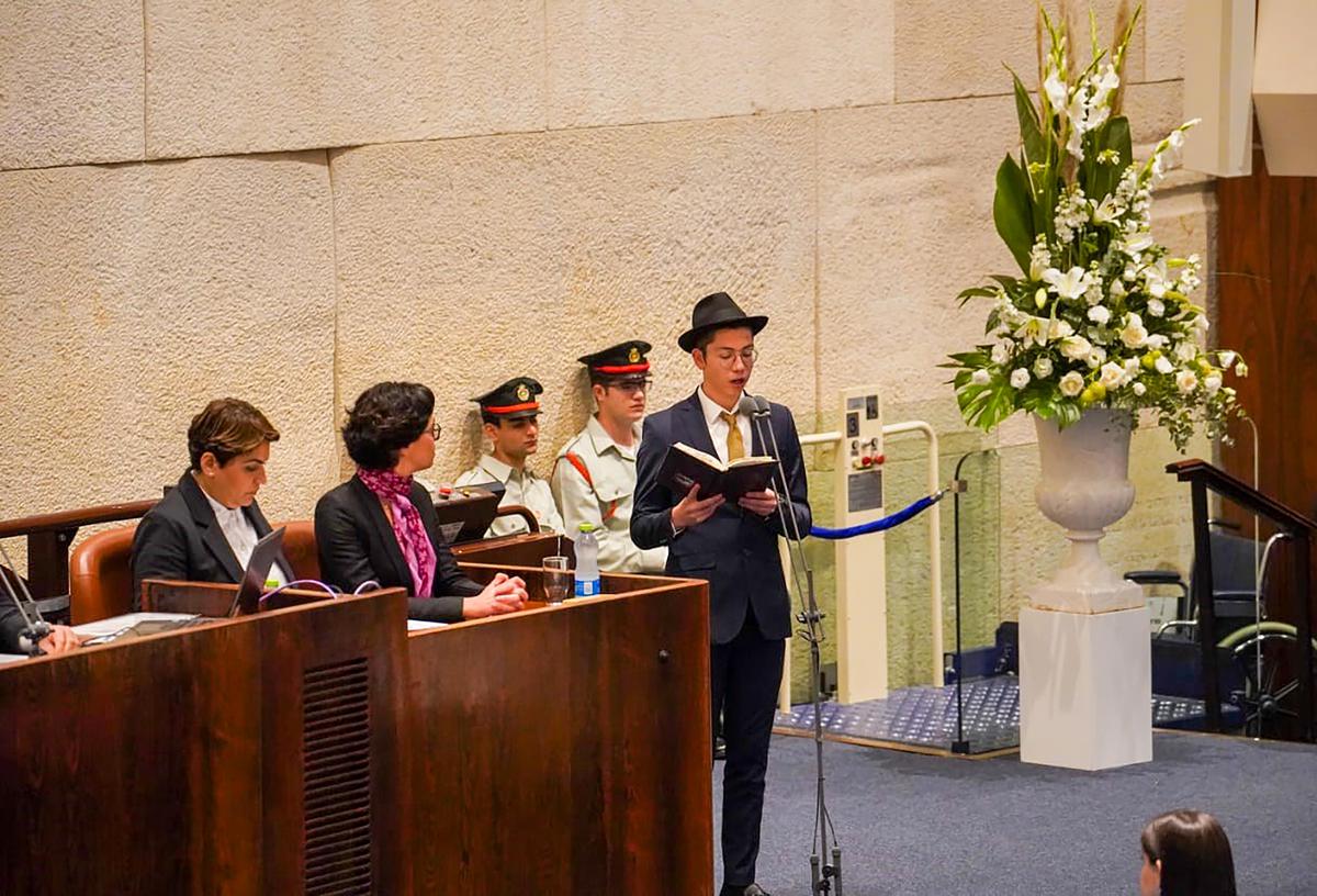 Moshe Holtzberg, the toddler survivor of 26/11, recites Psalm 122 from the Books of Psalms at the inaugural ceremony of the newly-elected Knesset (Israeli parliament), in Jerusalem on November 15, 2022. Photo: Twitter/@IsraelinIndia via PTI