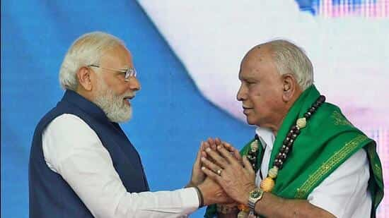 Prime Minister Narendra Modi felicitates former Karnataka chief minister BS Yediyurappa, in Shivamogga on Monday. (ANI/PIB)