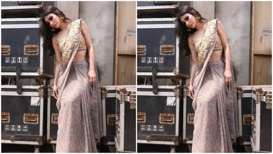 Mouni draped the grey printed georgette saree featuring embroidery patterns in shades of ochre as she posed for the outdoor photoshoot. (Instagram/@imouniroy)