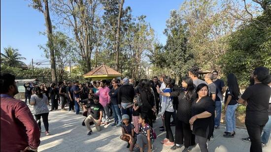 Around 70 citizens, including children, gathered at Sankey Tank park clad in black and sat silently briefly. During the protest, children and women were seen hugging the trees. (HT Photo)