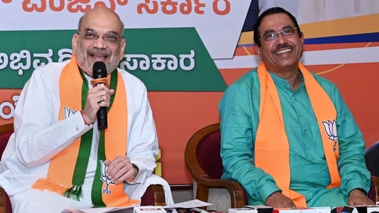 Union Home Minister Amit Shah with Union Minister Pralhad Joshi in Hubballi on Monday.(PTI)