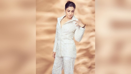 To complete her look, Raveena paired her white-colored blazer with matching white pants featuring straight-leg silhouette. (Instagram/@officialraveenatandon)