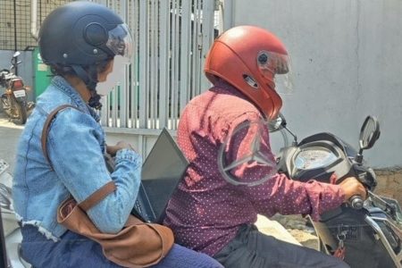 Twitter debate ensues after post on woman working on a laptop while on bike | Bengaluru