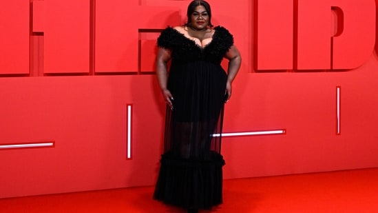 Da'Vine Joy Randolph made heads turn at The Idol after-party in a sensational black gown featuring a plunging V neckline, ruffled embellishments on the bodice and hem, a see-through skirt, and a figure-skimming fitting. Bold red lips, a messy hairdo and high heels added the oomph factor to the look. (AFP)