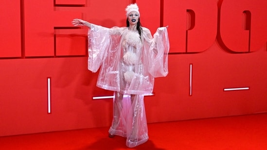 Pop culture icon and model Julia Fox chose to bare it all at The Idol after-party event. She chose an oversized see-through top adorned with fur ball embellishments for the occasion. Matching pants, heels, bold black lip shade, striking makeup, and a quirky cap rounded it off. (AFP)