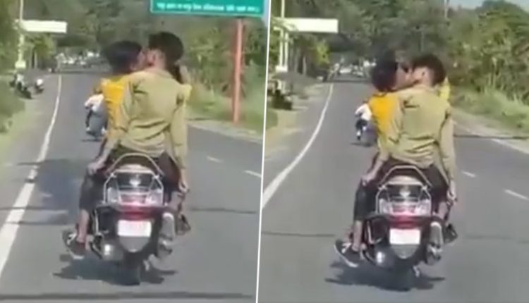 Guys Kissing in UP Viral Video: Boys Indulge in Passionate Lip-Lock on Moving Scooty in Rampur, Manhunt Launched
