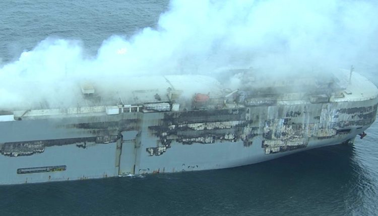 Burning car carrier being towed to new location off Dutch coast