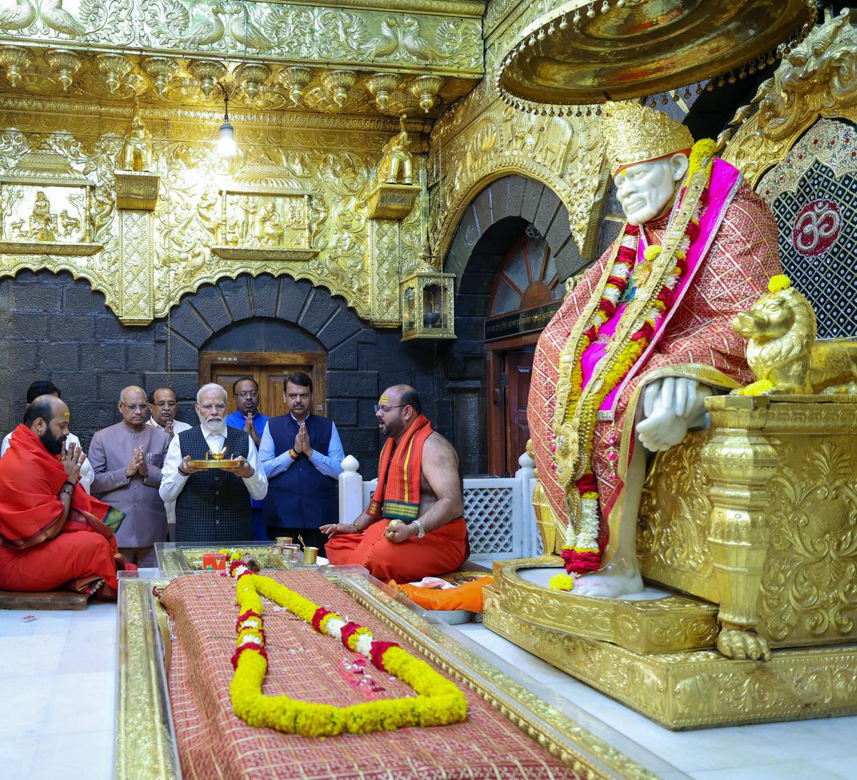  Prime Minister Narendra Modi performs aarti while offering prayers with Maharashtra Governor Ramesh Bais, State Deputy Chief Minister Devendra Fadnavis and others at Shri Saibaba Samadhi Temple, in Shirdi on Thursday. 