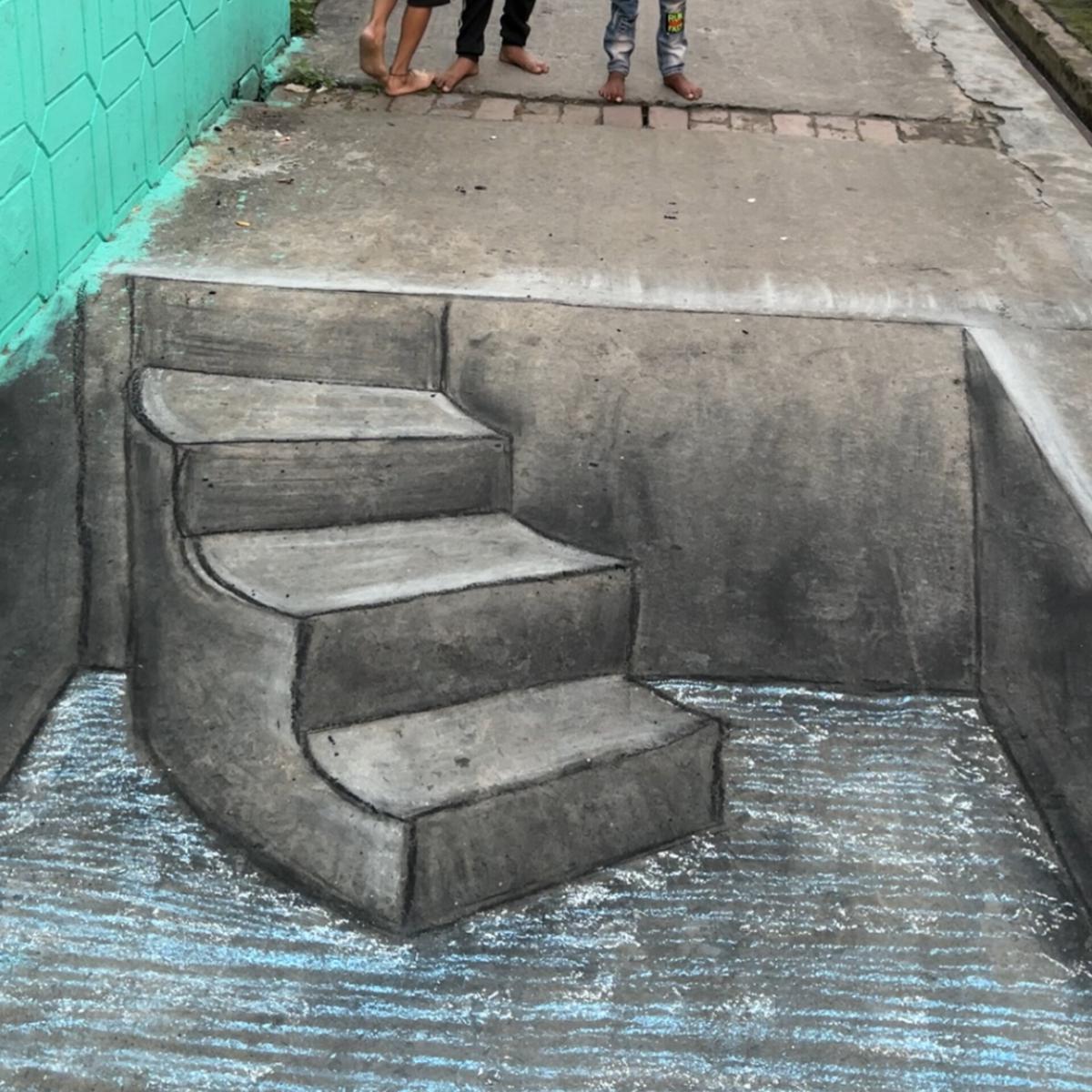 A 3D art of an underground well with stairs done by Punam using just charcoal and chalk.