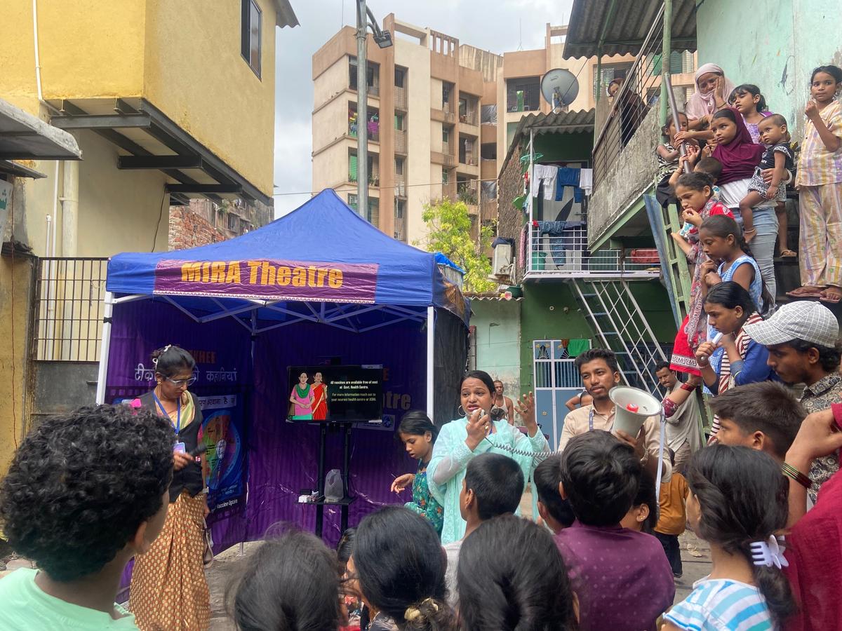 Transgender field coordinator Amrien (centre, in green) mobilising the community in Azad Nagar, Kausa.