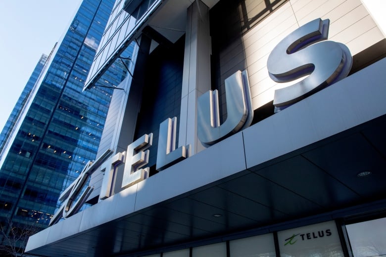 The word 'Telus' appears over the entrance to a skyscraper
