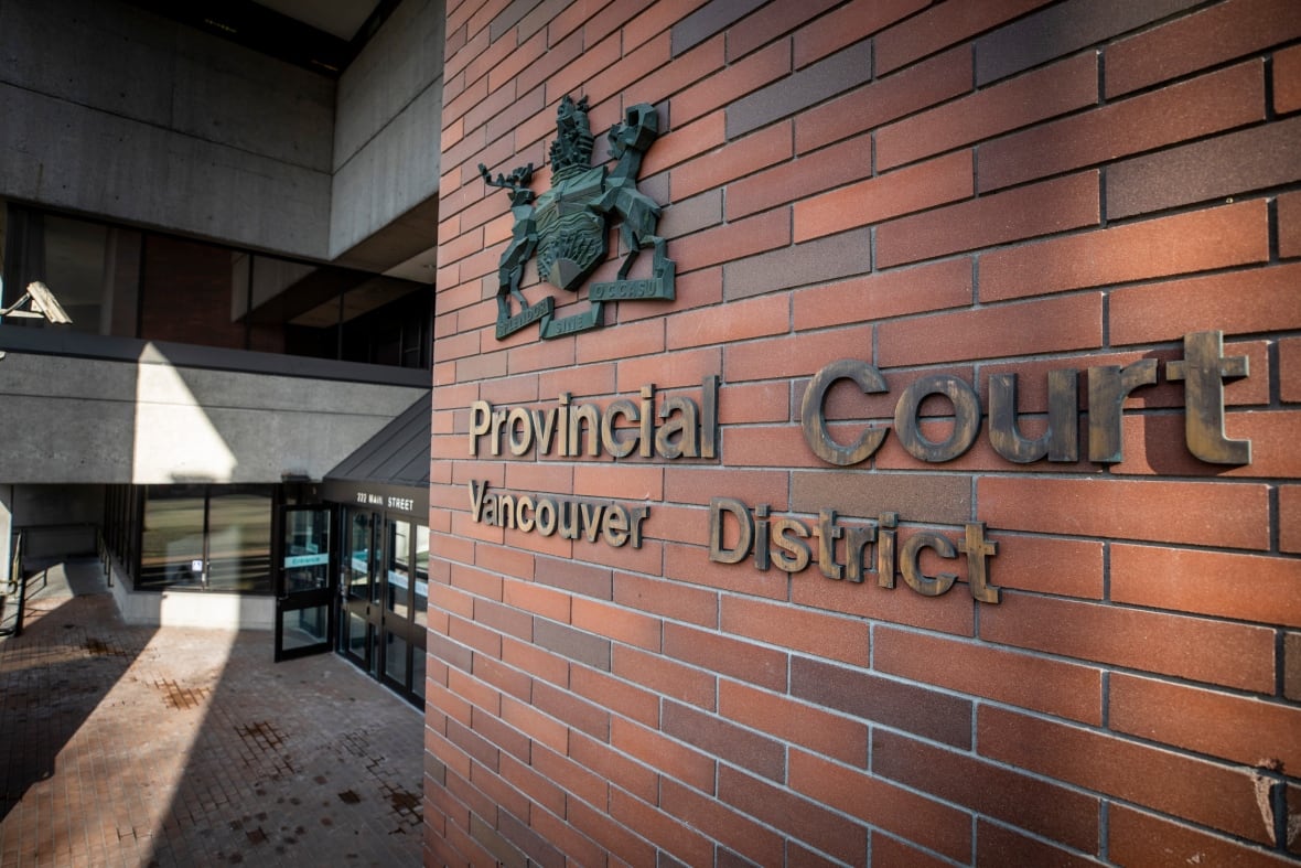 A brick building with a seal, and a sign reading 'Provincial Court Vancouver District.'