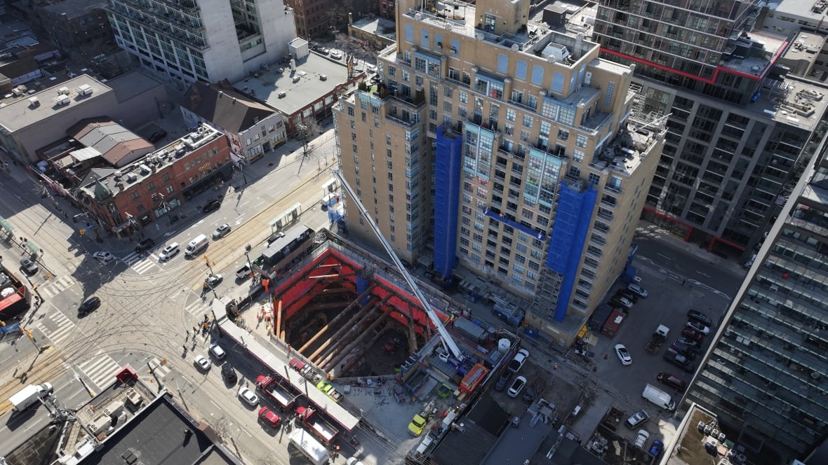 An aerial view of Ontario Line construction work near Toronto's Queen Street and Spadina Avenue intersection.