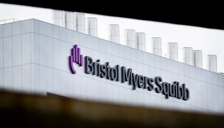 We're lowering our price target on Bristol Myers as two key overhangs persist