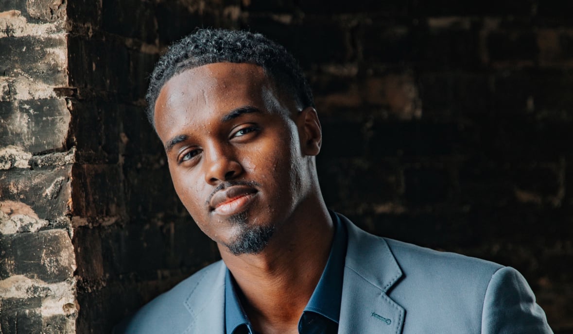 A man standing by a wall.