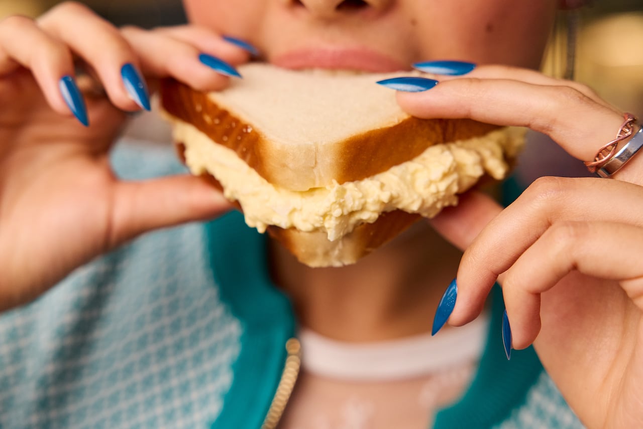 Hands holding up a sandwich