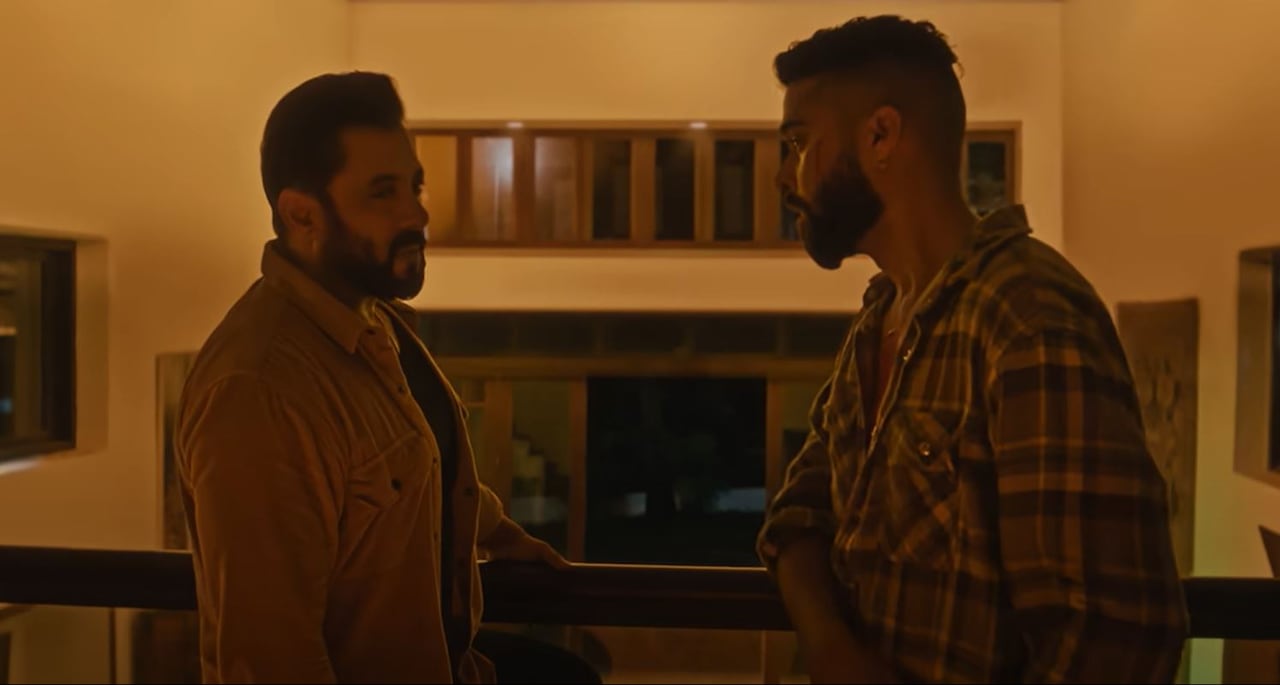 Two South Asian men are seen opposite each other.