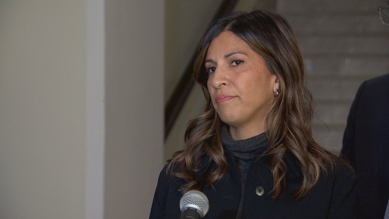 A woman speaks into a microphone.