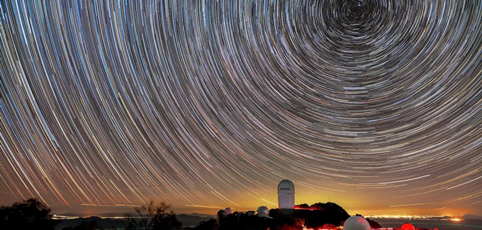 The track of stars trace concentric circles in the sky over an observatory in this time-lapse image.