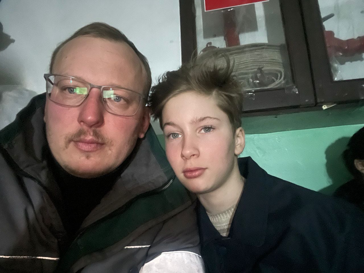 In this photo taken on April 10, 2022, Serhii Kesarev sits with his 11-year old son in the basement of a building in Mariupol. They fled the city about a week later. 
