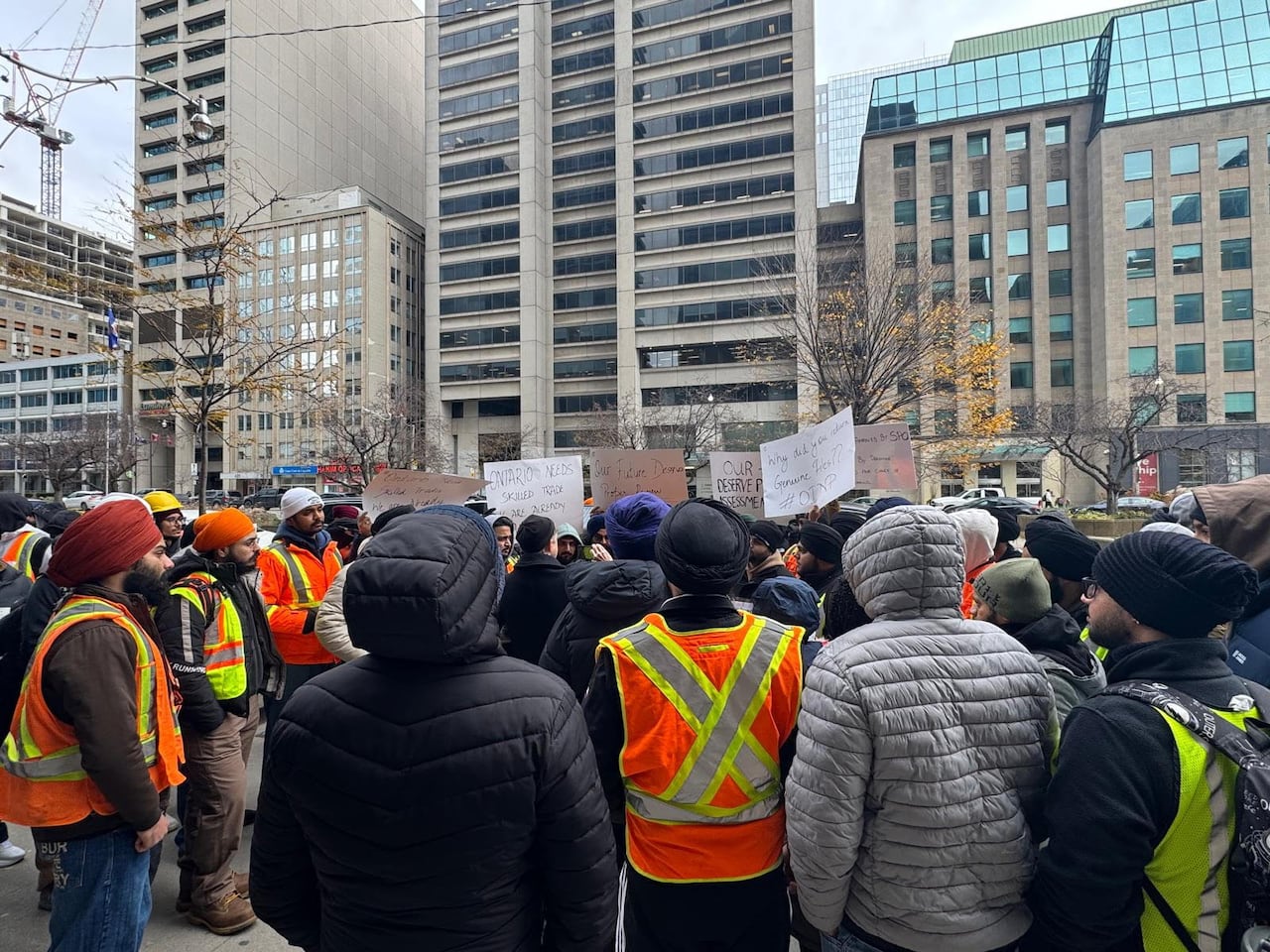 A group of protesters gather outside of a government office in Toronto.