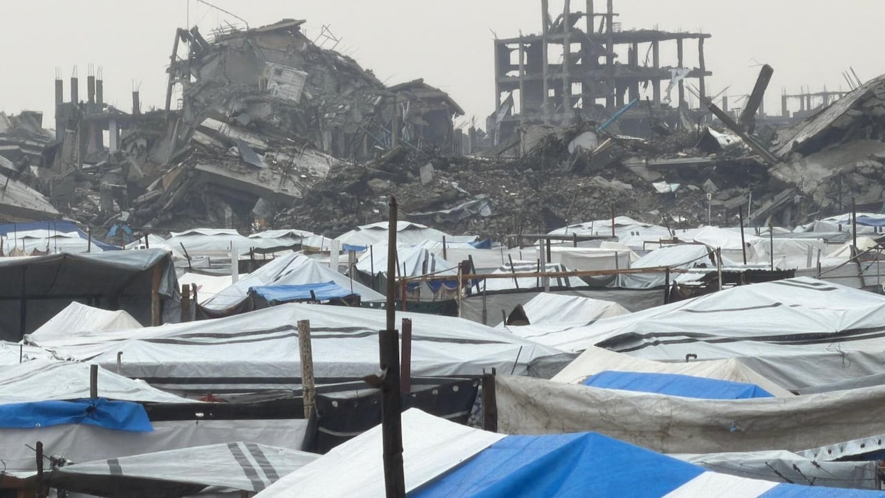 Tents seen across from destroyed buildings.