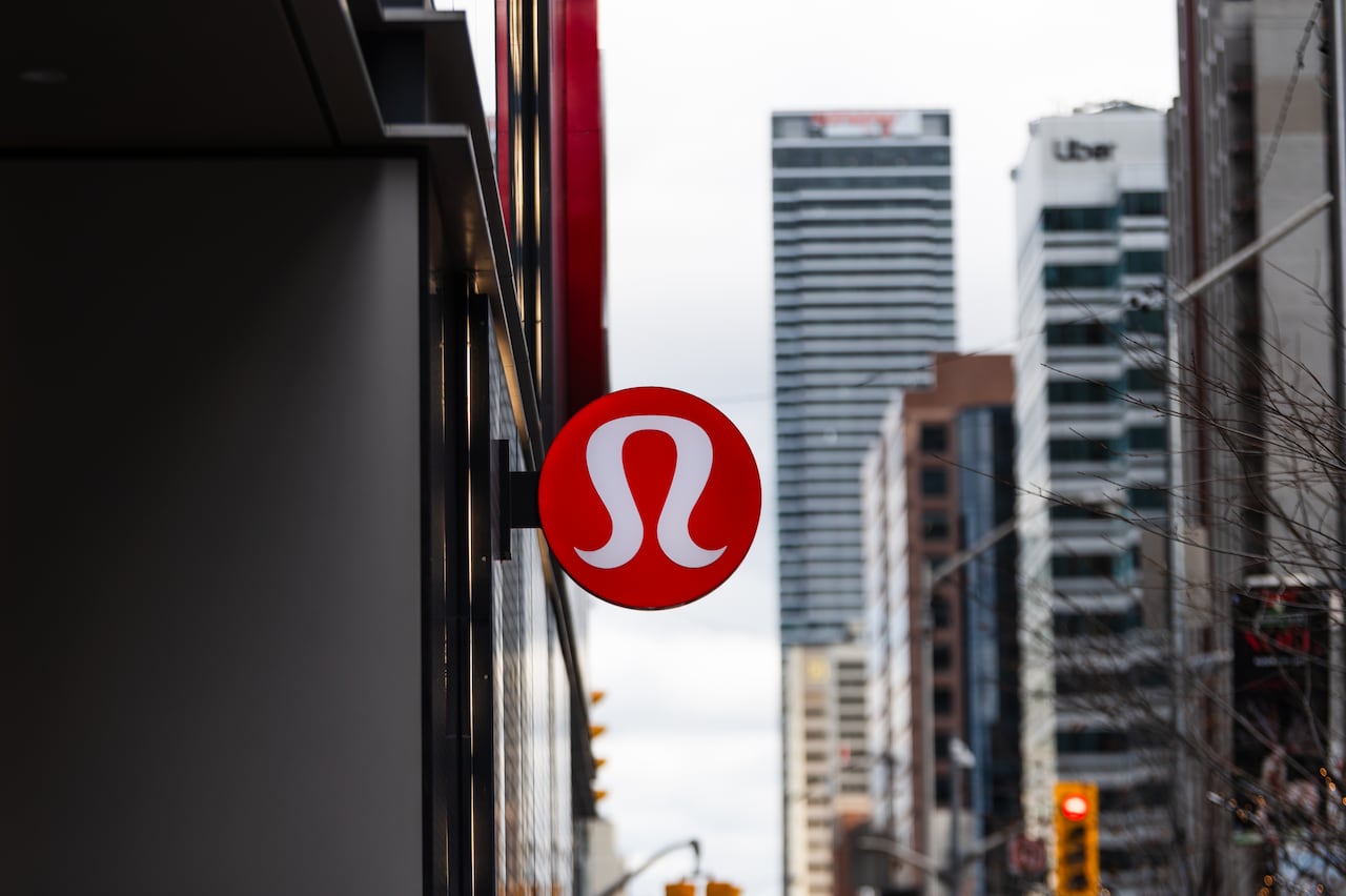 A close-up of a Lululemon logo on a sign