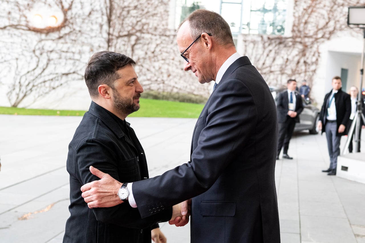 Two people shake hands.